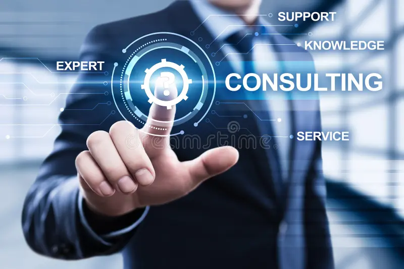 A man in a suit touches a holographic interface displaying the words "Consulting," "Expert," "Support," "Knowledge," and "Service," conveying innovation.